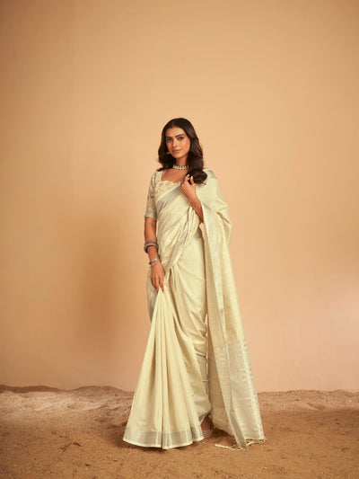 Woman wearing an Elora soft linen cream saree with beautiful foil print